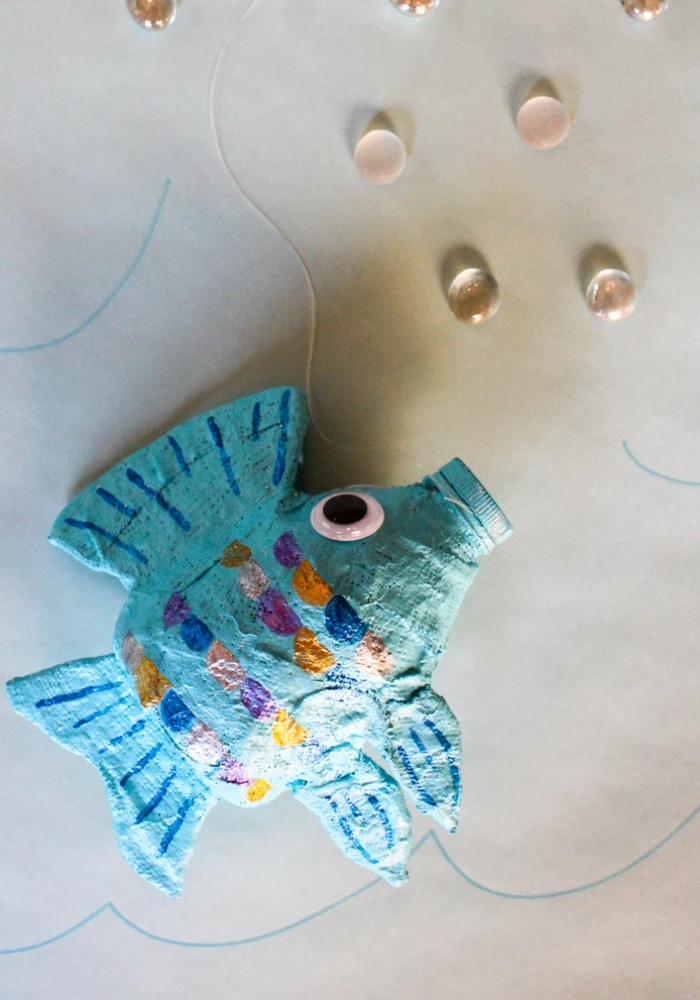 Make a fish sculpture with an empty water bottle and Rigid Wrap plaster cloth!  This free lesson plan will show you how to use water bottles as armatures to create fun projects for the art room.  #armature #fishsculpture #lessonplan